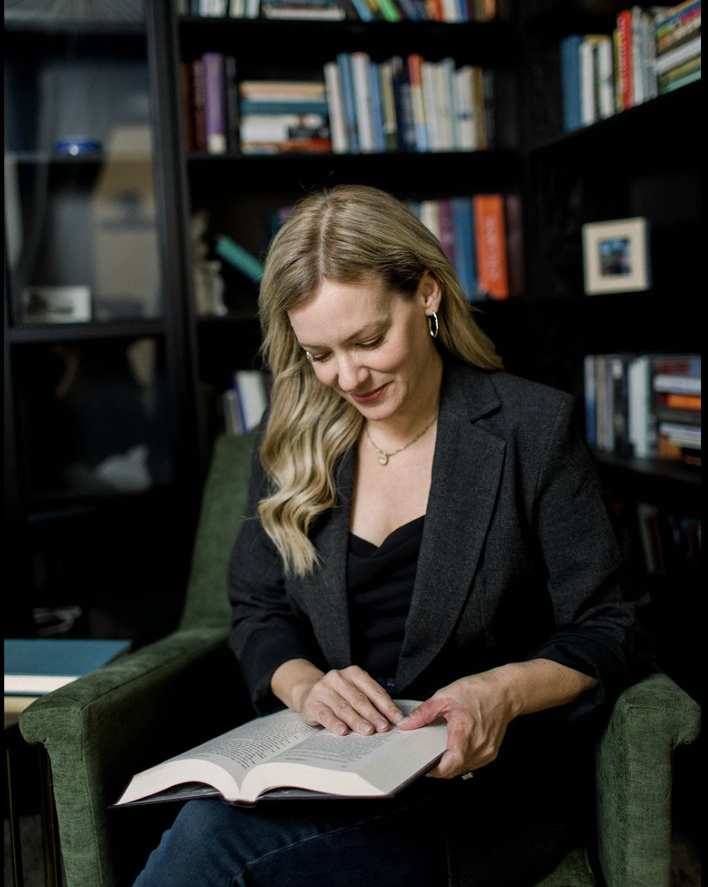 Carey reading in her library